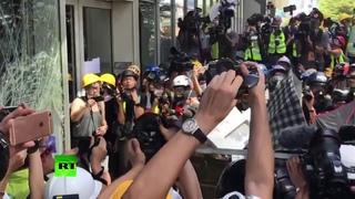 Hong Kong protesters batter council building windows with trolley